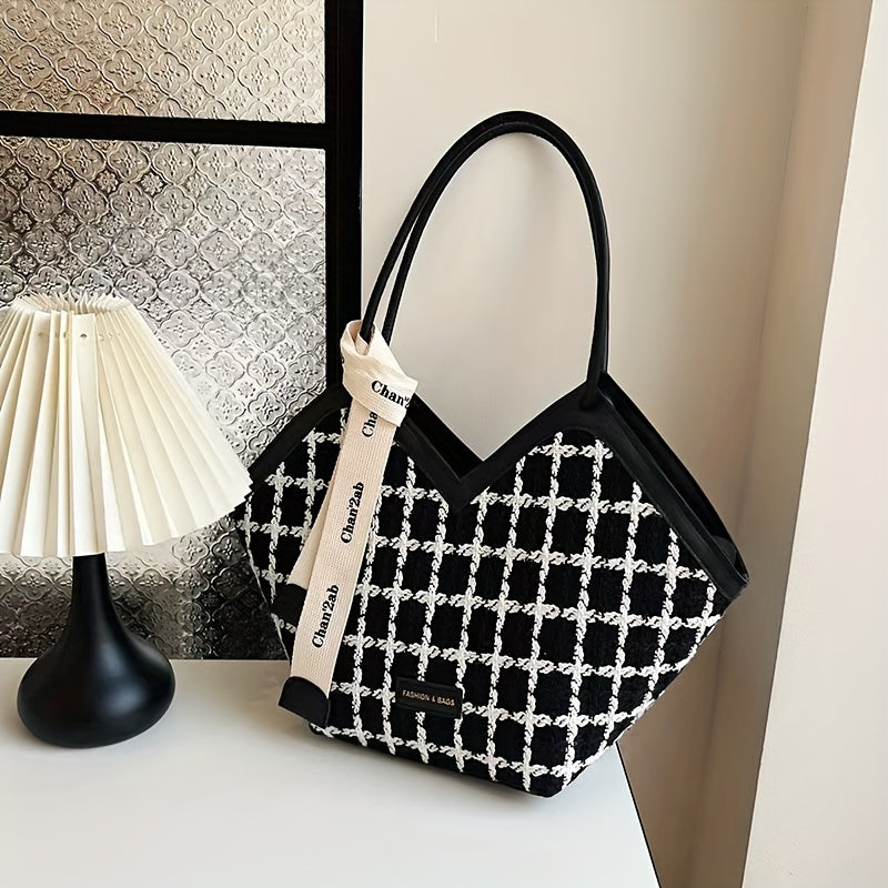 Stylish black plaid tote bag for women, spacious with zip closure and matching strap.