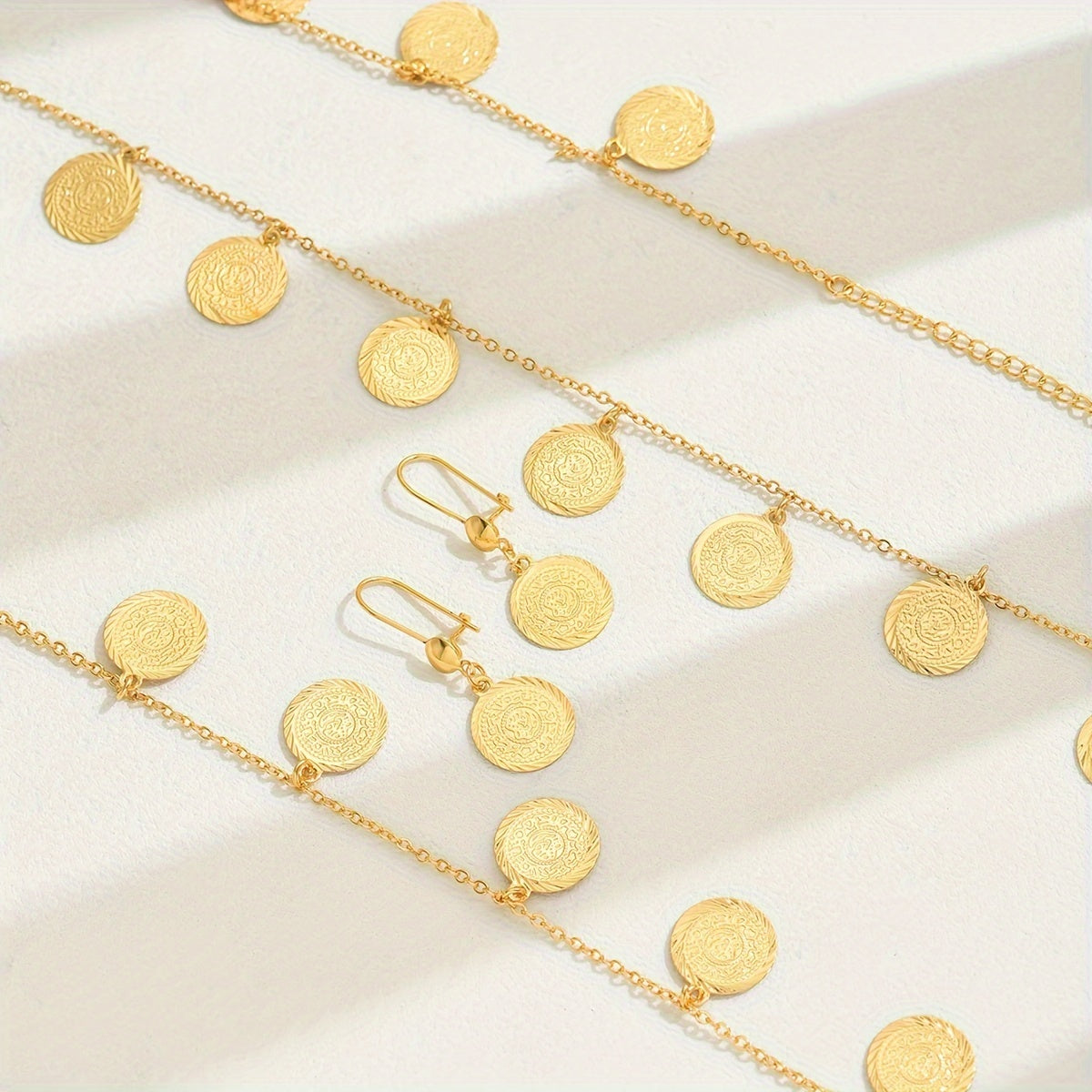 Introducing a new two-piece set featuring relief gold coins, a retro fashion long necklace, and matching earrings. This set exudes light luxury and is versatile for women looking to make a statement during Ramadan.