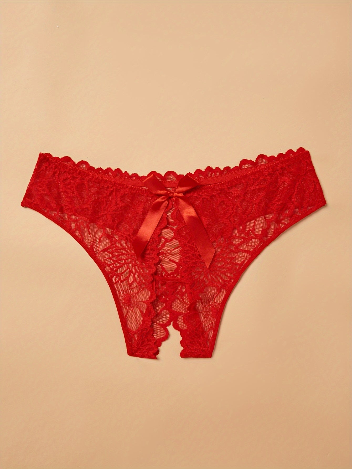 Plus size lace thong panties for women with back bow detail, made of nylon for a comfortable fit.