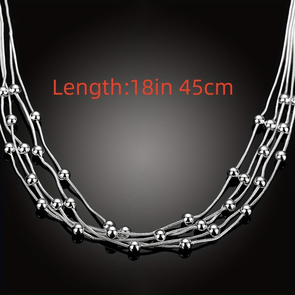 Stunning women's fine jewelry plated in a beautiful sterling silver color necklace. The 45.72cm necklace features five lines of beads on a snake chain, with charm balls for a unique and elegant look. This multilayer necklace is perfect for a lady to wear