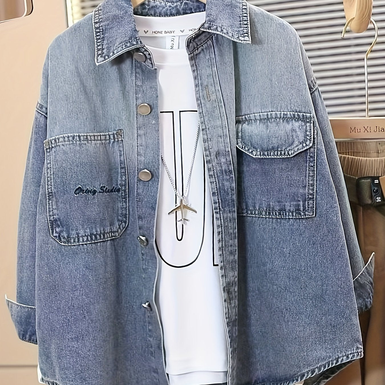 Boys' trendy denim jacket with loose fit, button-up front pockets and turn collar. Machine washable, perfect for fall/winter. Fashion-forward design with metallic buttons.