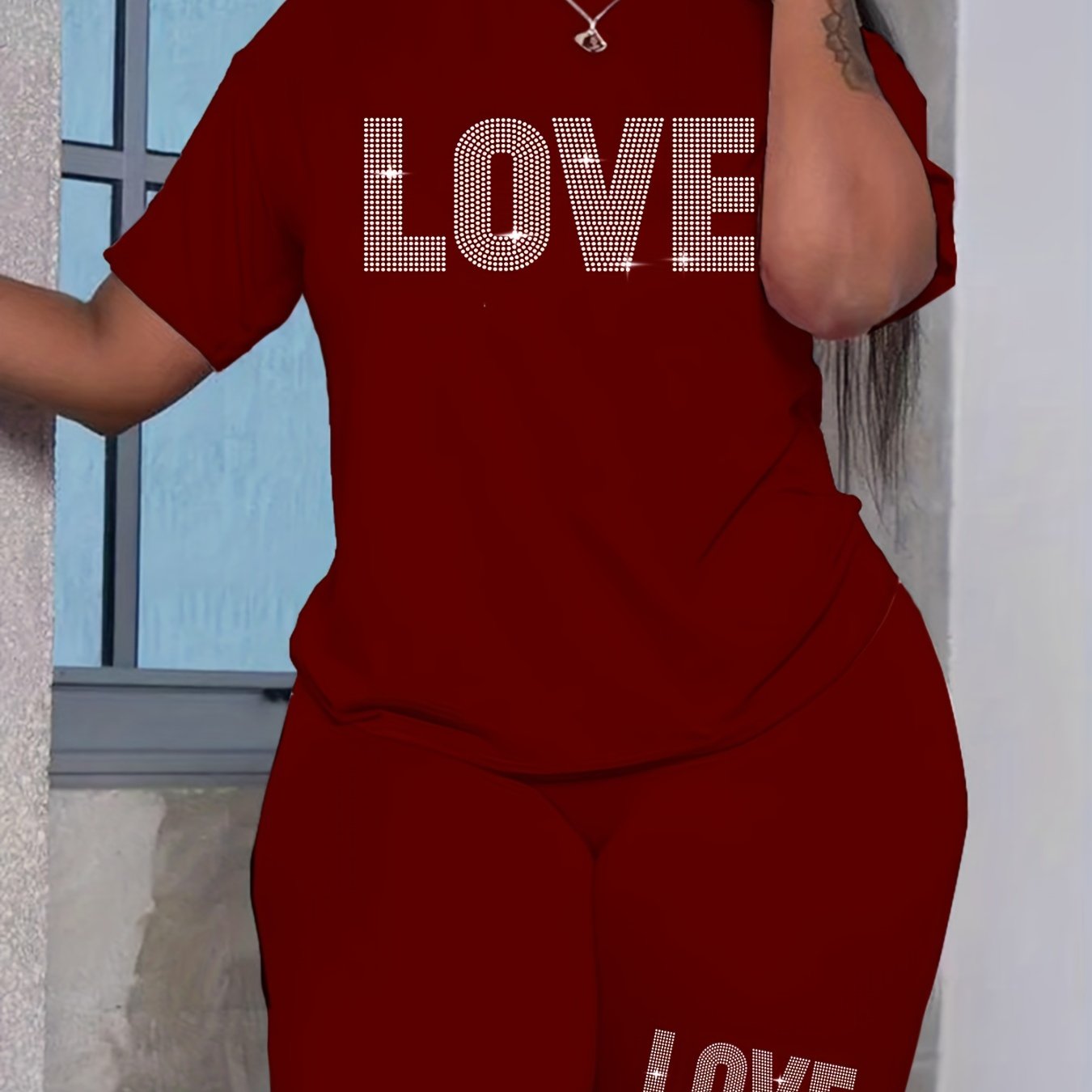 Plus-size women's casual polyester T-shirt and shorts set with alphabet love print, ideal for daily wear.