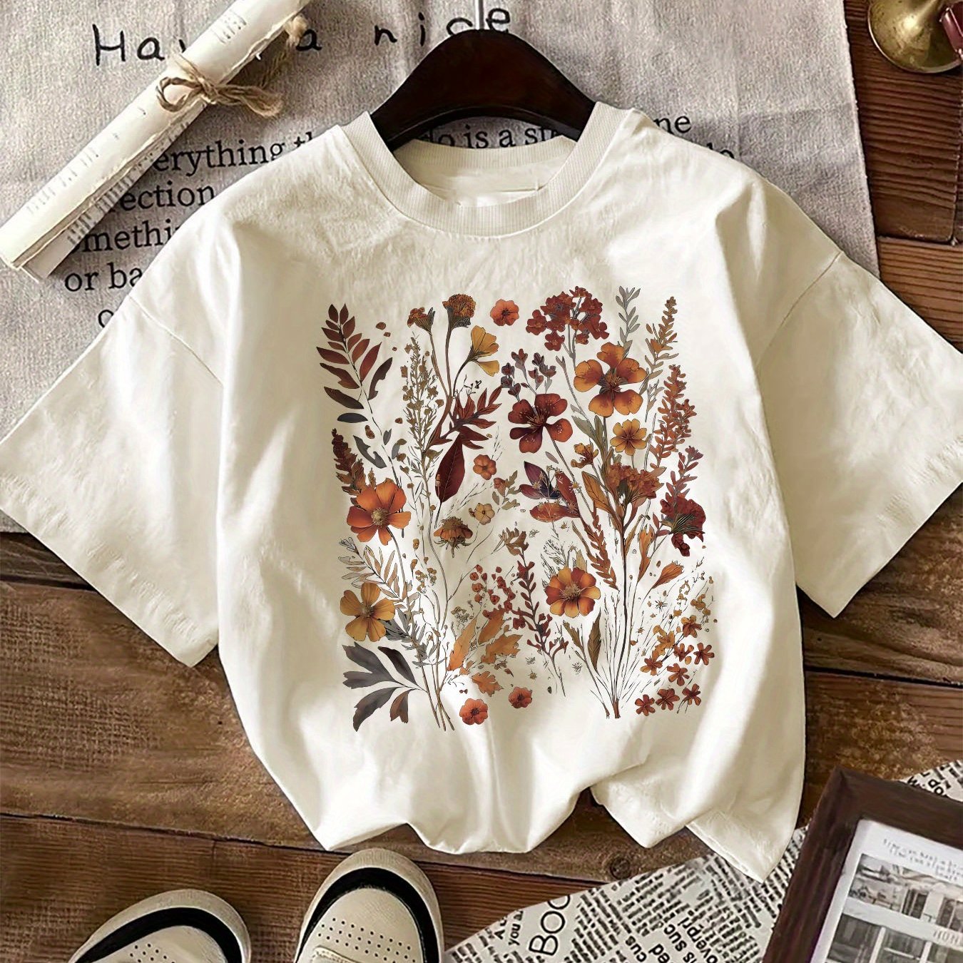 Women's floral graphic print t-shirt with crew neck, short sleeves, and regular length, suitable for all seasons. Made of 100% knit fabric weighing 180gsm.