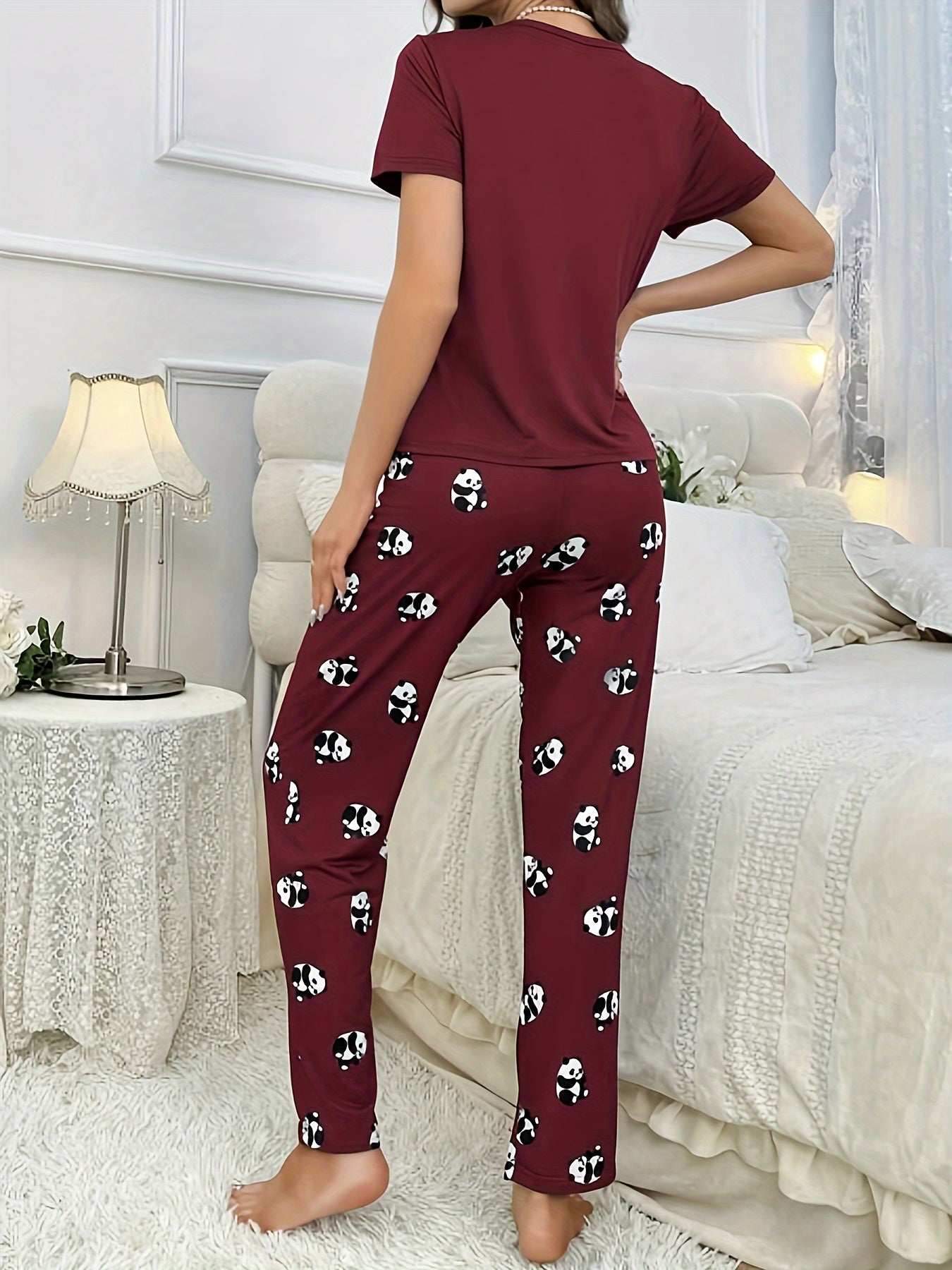 Women's sleepwear set with cute panda print, short sleeve top, and elastic pants.