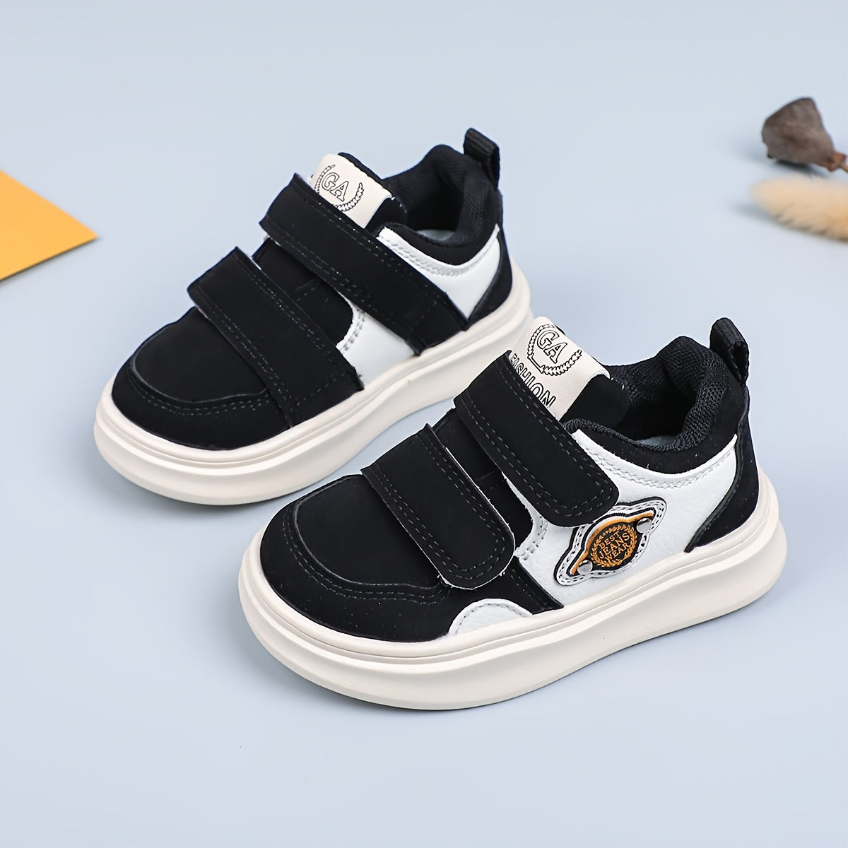 Casual low top sneakers for boys and girls with hook & loop closure, breathable faux upper, rubber sole, fabric insole, and round toe design.