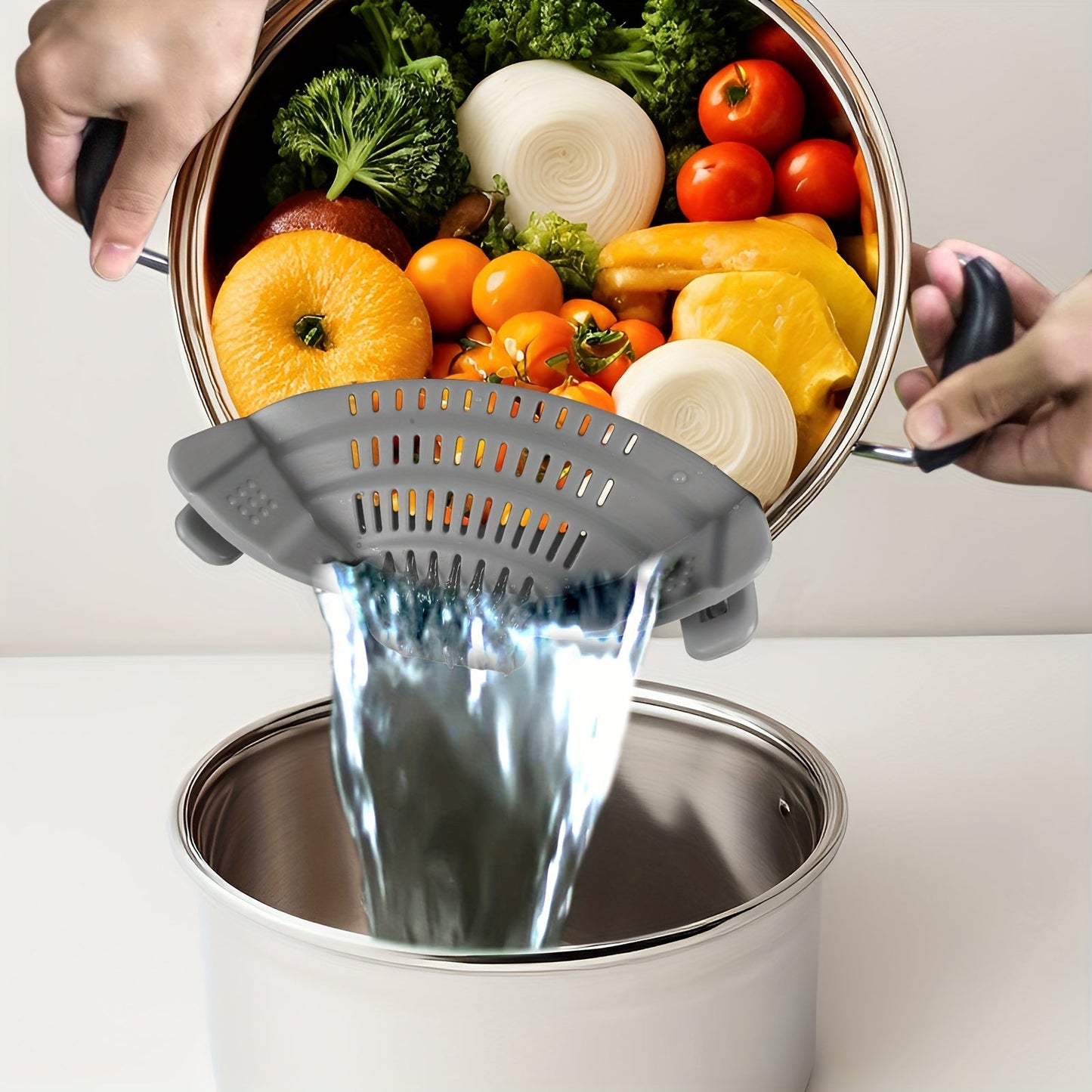 Adjustable clip-on strainer for pots and pans, made of plastic. Perfect for straining pasta, meat, vegetables, and fruit. An essential kitchen colander accessory.