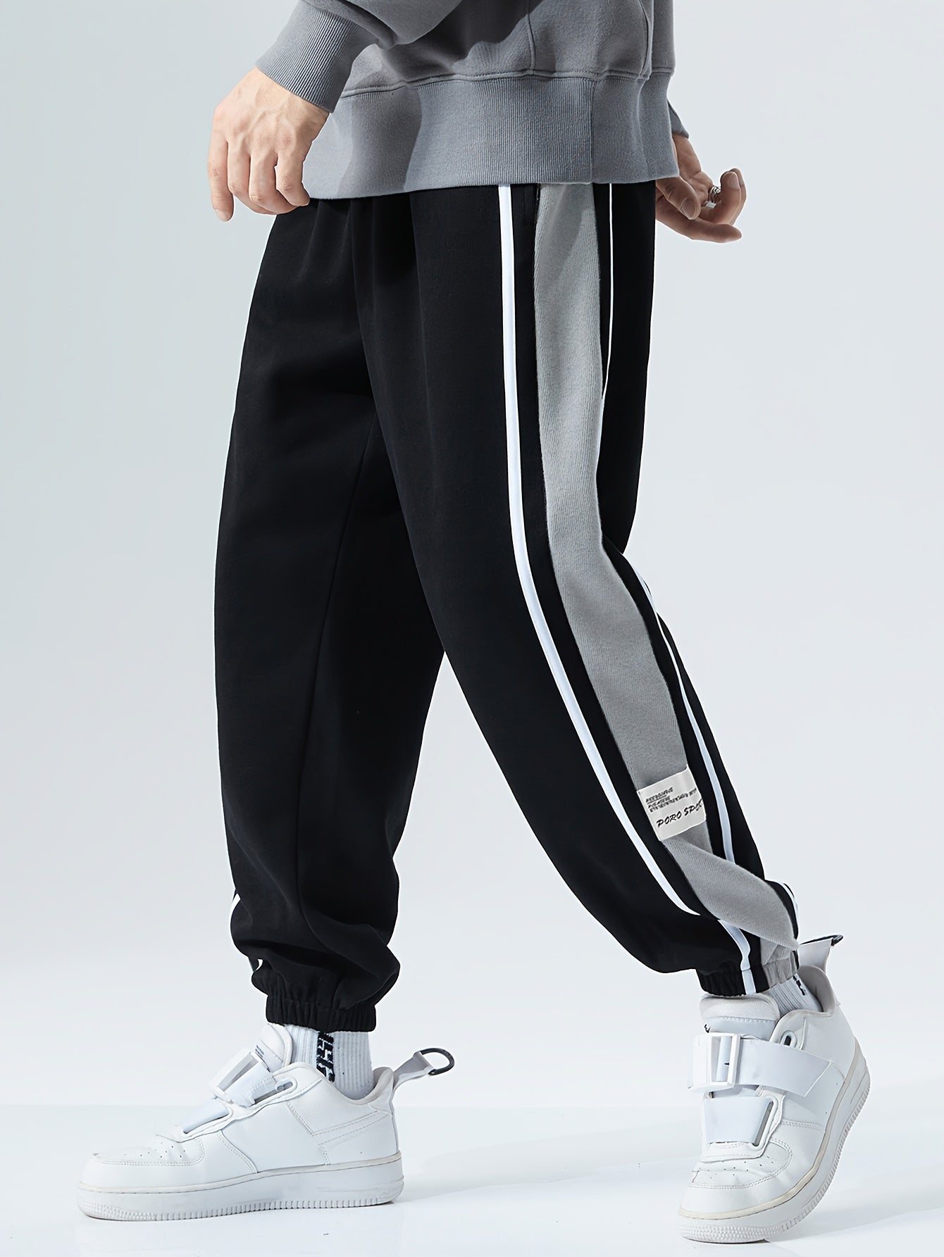 Men's loose sports pants for summer and fall, trendy style, available in large sizes, suitable for casual wear.