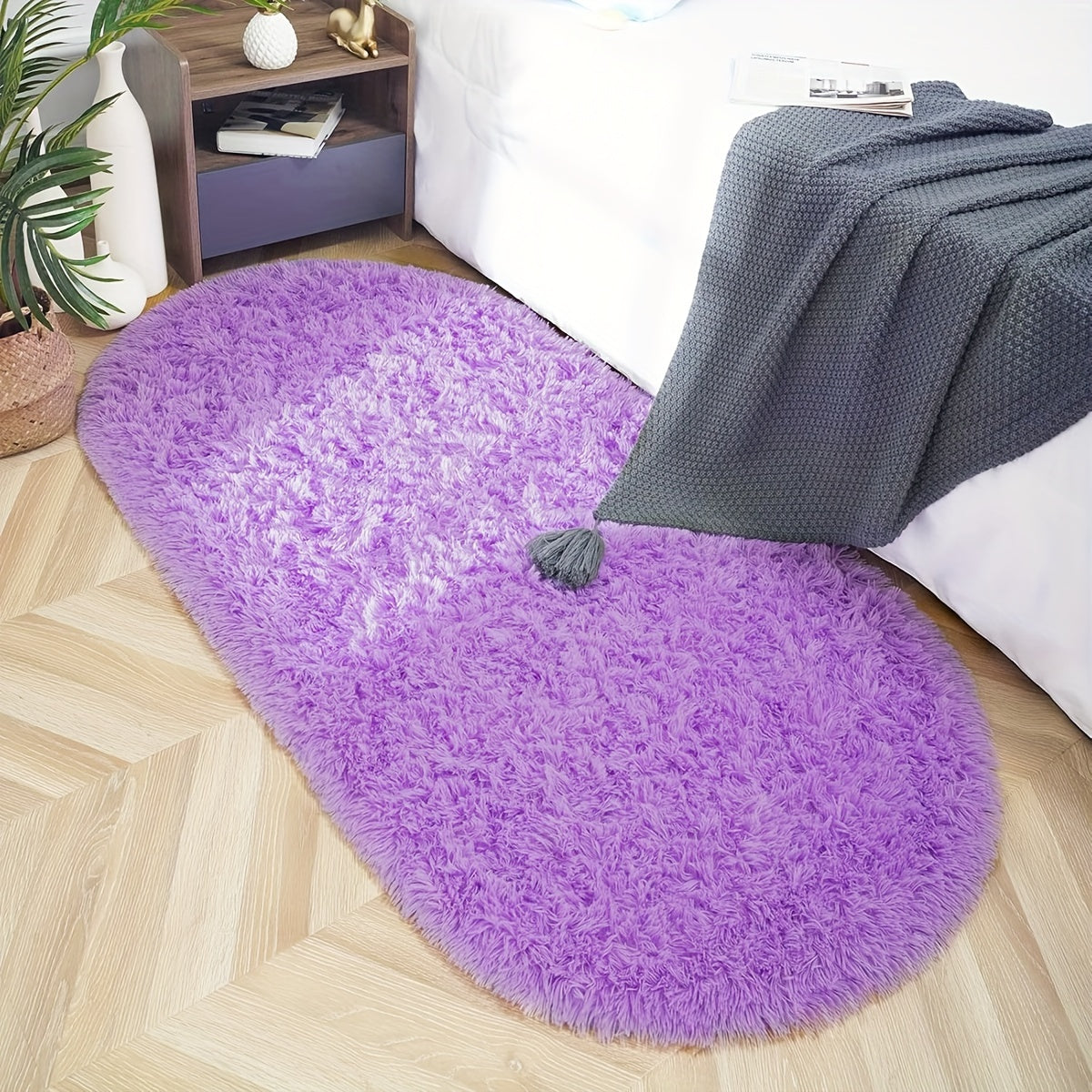 Soft and fluffy oval shaggy area rug, perfect for bedroom or living room. Made with skin-friendly thickened sponge and tufted polyester material. Durable and easy to maintain. Adds decorative touch to indoor spaces such as sofa, bedside, playroom, or