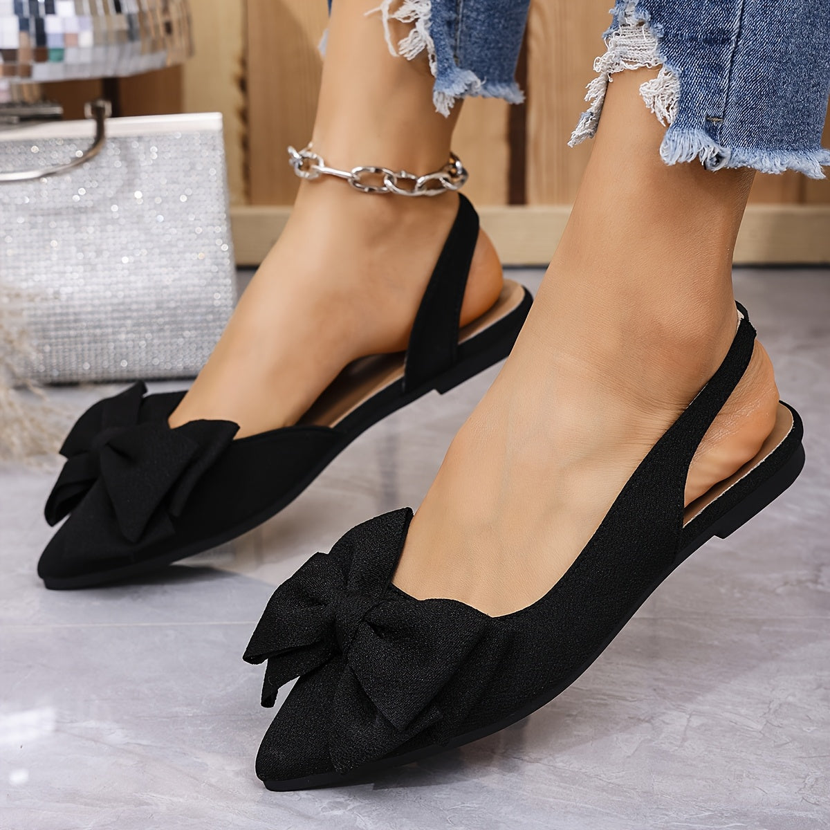 Women's bow-knot flat sandals with pointed toe, fabric upper, and rubber sole for all seasons.