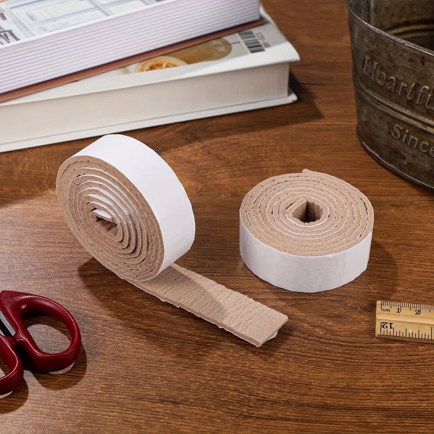 Two rolls of beige self-adhesive felt tape for non-slip furniture protection on hardwood floors, chairs, and walls. Each roll is 3.05 meters long, 2.54 cm wide, and 0.3 cm thick. Great for protecting your surfaces from scratches and damage.