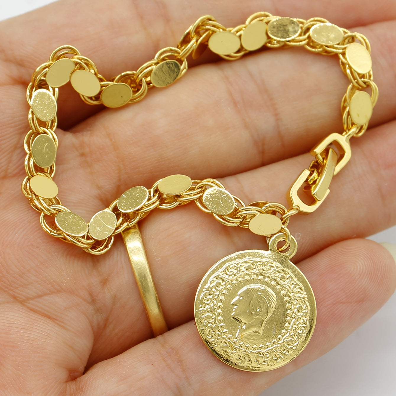 A handmade bracelet adorned with a gold-plated Turkish lira pendant, perfect for everyday or special occasions.