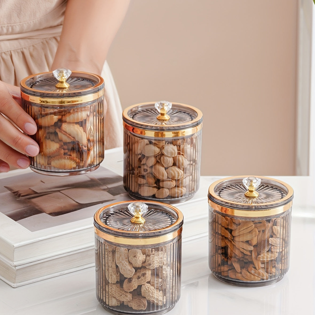 One piece of a transparent amber sketch golden grey bead decorated jar with a lid for candies. Made of plastic, can only be hand washed. It is a reusable sealed fresh-keeping box for storing cereal, rice, pasta, tea, nuts, and coffee beans. Perfect for