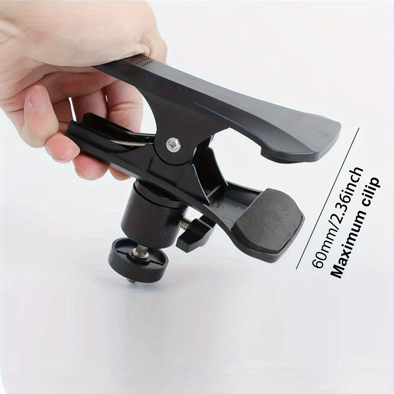 Black alloy cell phone clip for live streaming and recording musical instruments, doubles as a selfie holder.