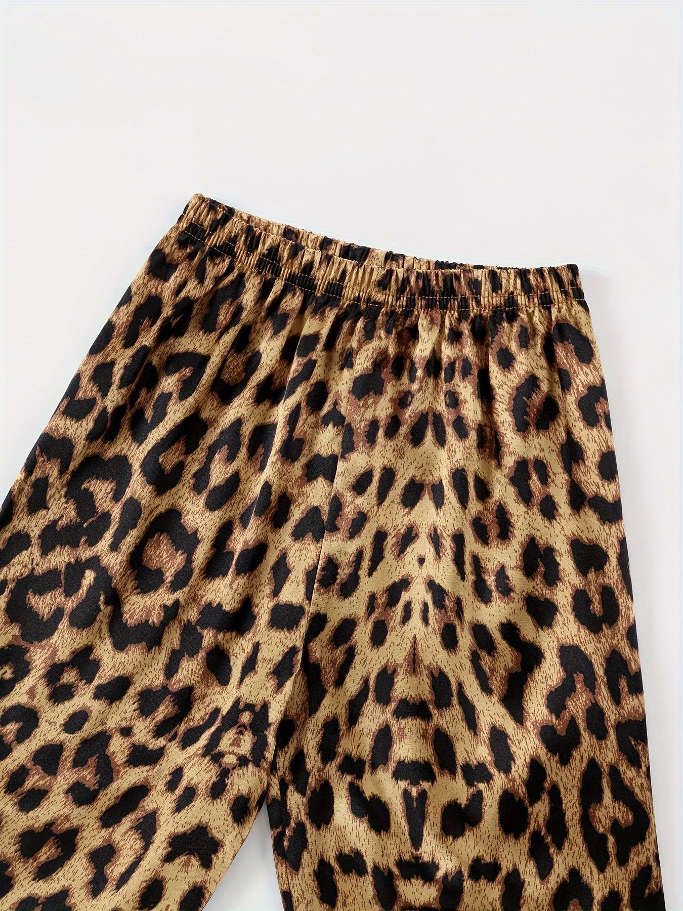 Comfortable leopard print pajamas with front buttons, long sleeves, elastic waistband, and long pants for home wear.