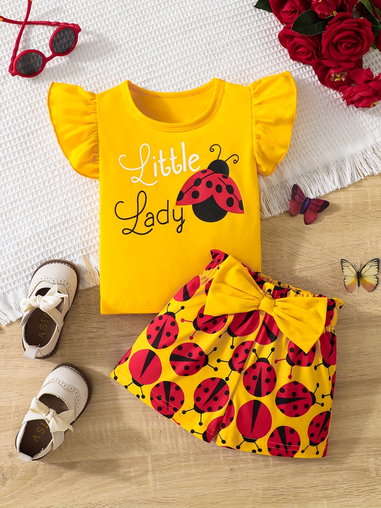 Ruffle sleeve graphic tee and ladybug shorts set for baby girl, perfect casual summer outfit.