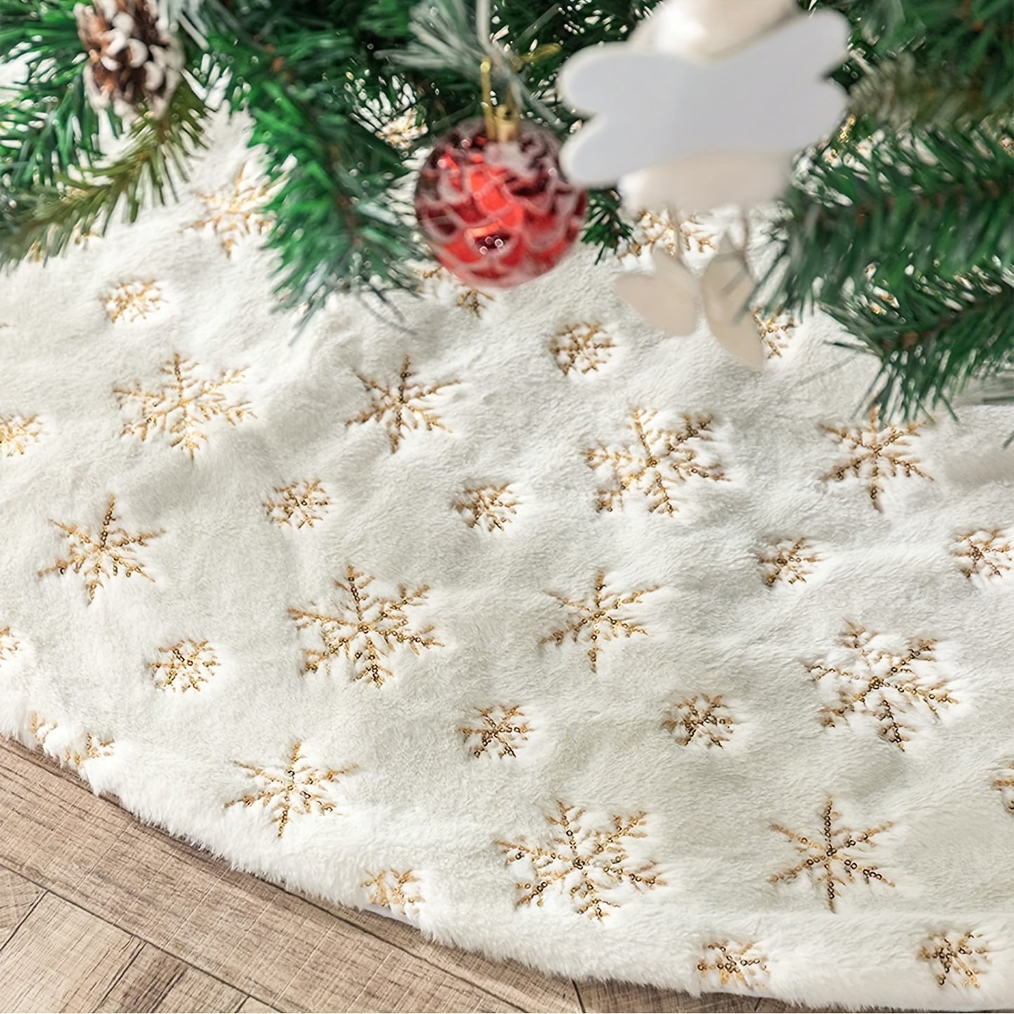 White velvet Christmas tree skirt with golden snowflake embroidery, ideal for Halloween, Christmas, and Valentine's Day. Festive holiday decoration with textured detailing.