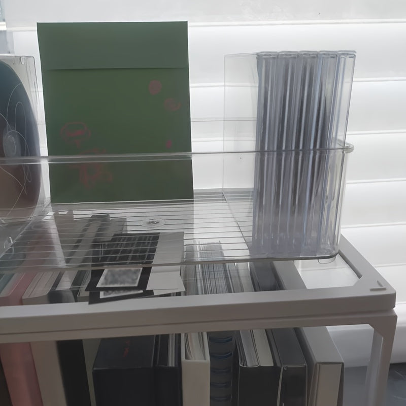 The Clear Acrylic CD/DVD Storage Basket is a sturdy and stylish solution for storing your media collection. This space-saving display rack can hold up to 20 standard cases, making it perfect for organizing your albums and games. Its durable construction