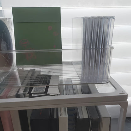 The Clear Acrylic CD/DVD Storage Basket is a sturdy and stylish solution for storing your media collection. This space-saving display rack can hold up to 20 standard cases, making it perfect for organizing your albums and games. Its durable construction