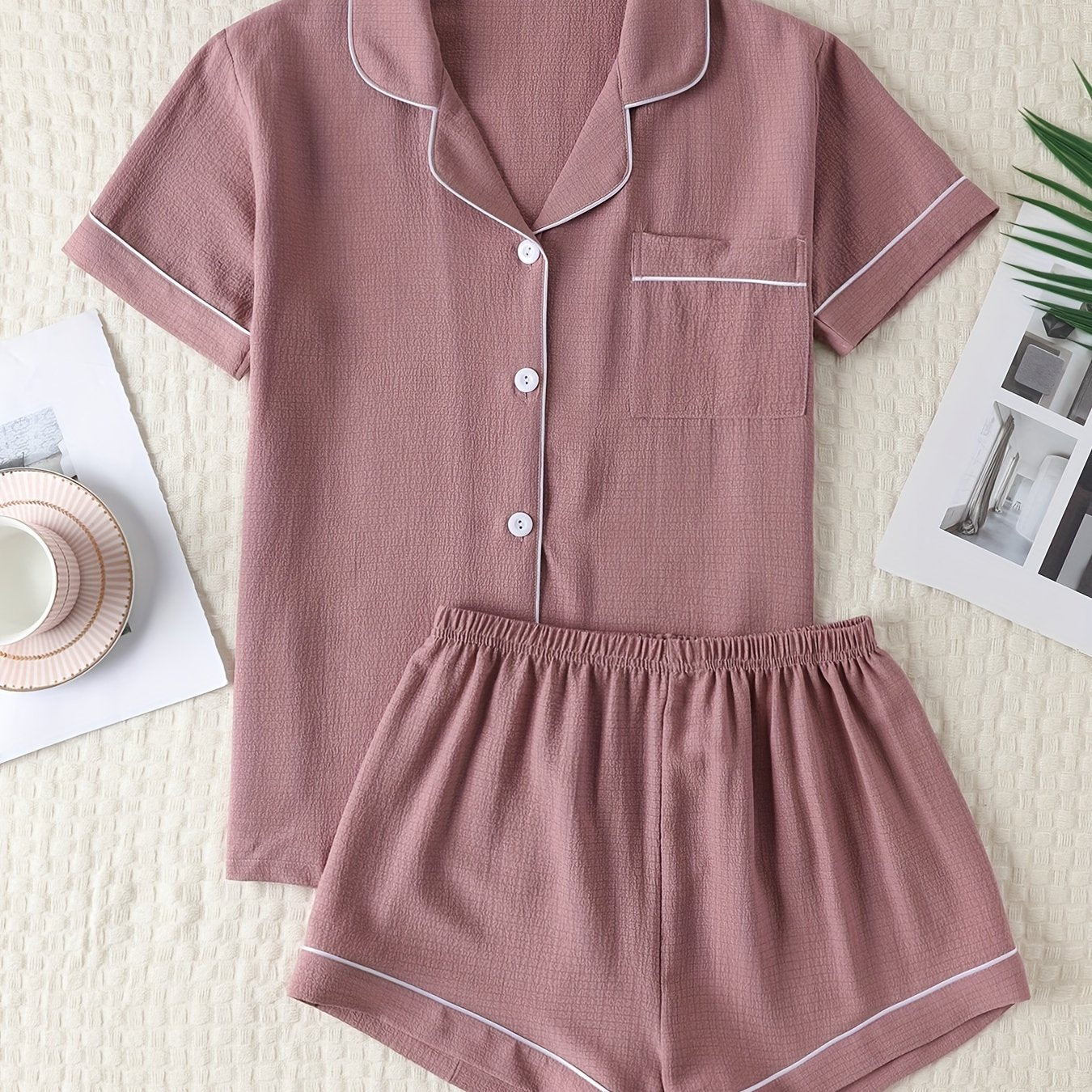 Basic pajama set for women, featuring a short-sleeve button-up top with lapel collar and elastic shorts.