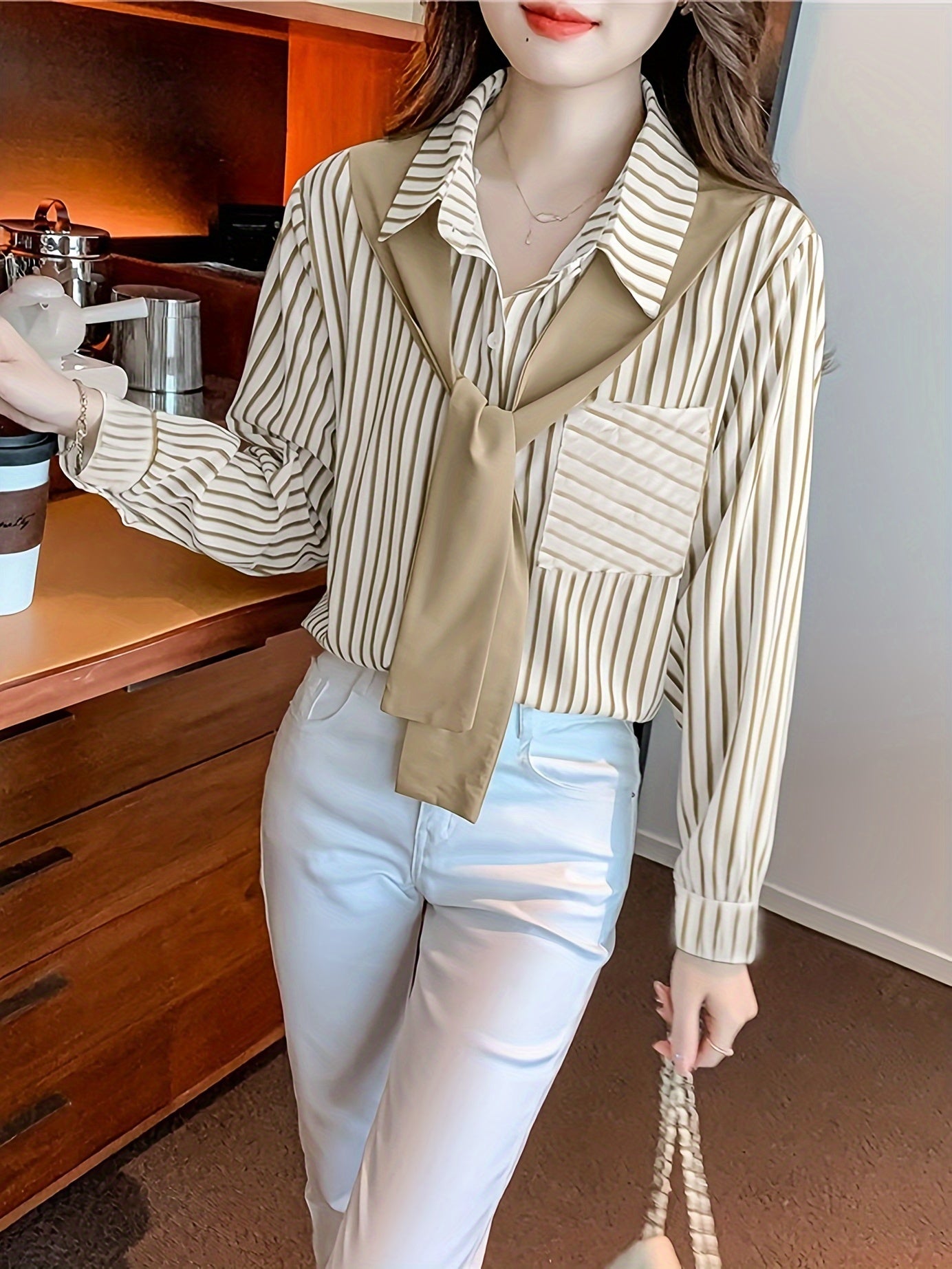 Elegant striped lace-up shirt with long sleeves and single breasted placket made of polyester, perfect for adults in spring/fall. Features a square neck.