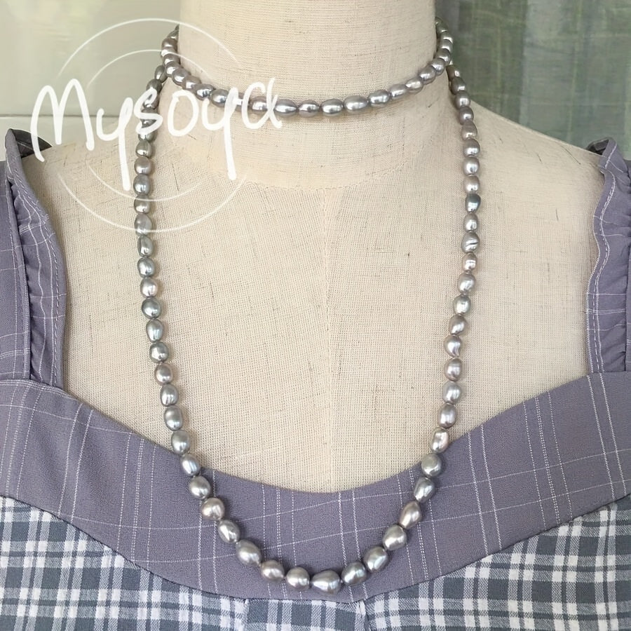 Handcrafted with care, the MYSOYA 100% Handmade Natural Gray Freshwater Baroque Pearl Long Necklace features pearls measuring 7-8mm in size. It comes packaged in a gift box and is suitable for both men and women. This versatile piece is ideal for