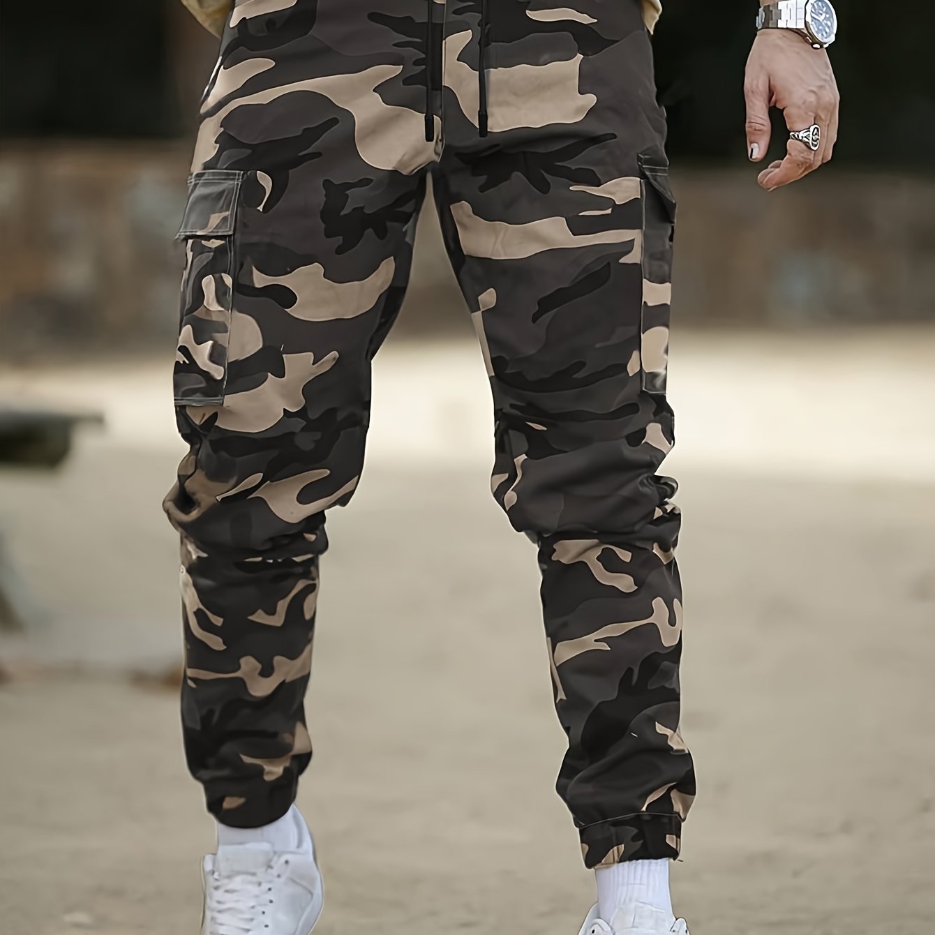 Men's camo cargo pants made from 100% non-stretch polyester fabric with a drawstring waist and flap pockets. Suitable for outdoor work.