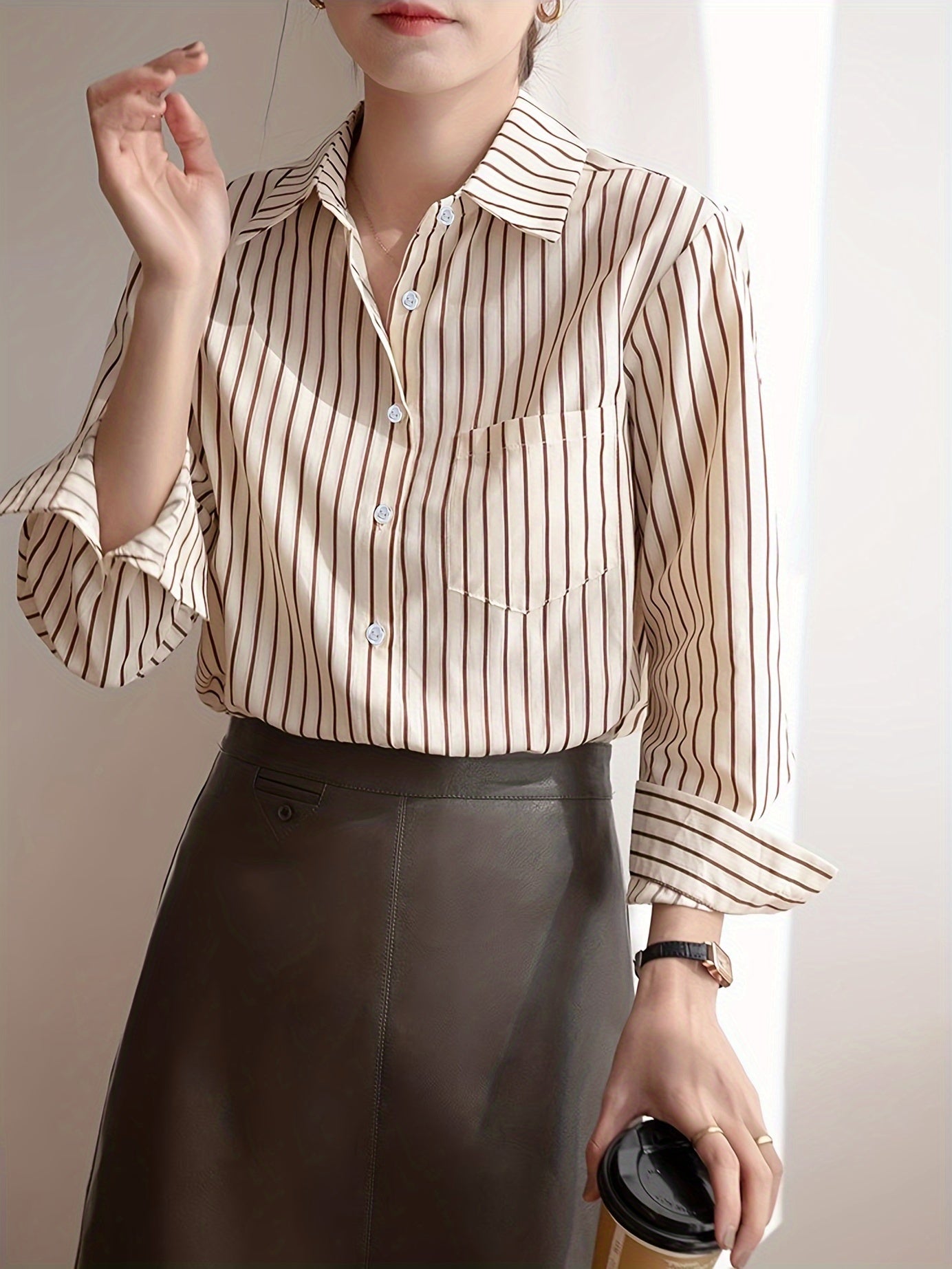 Beige striped blouse with button-up front, loose fit, machine washable.