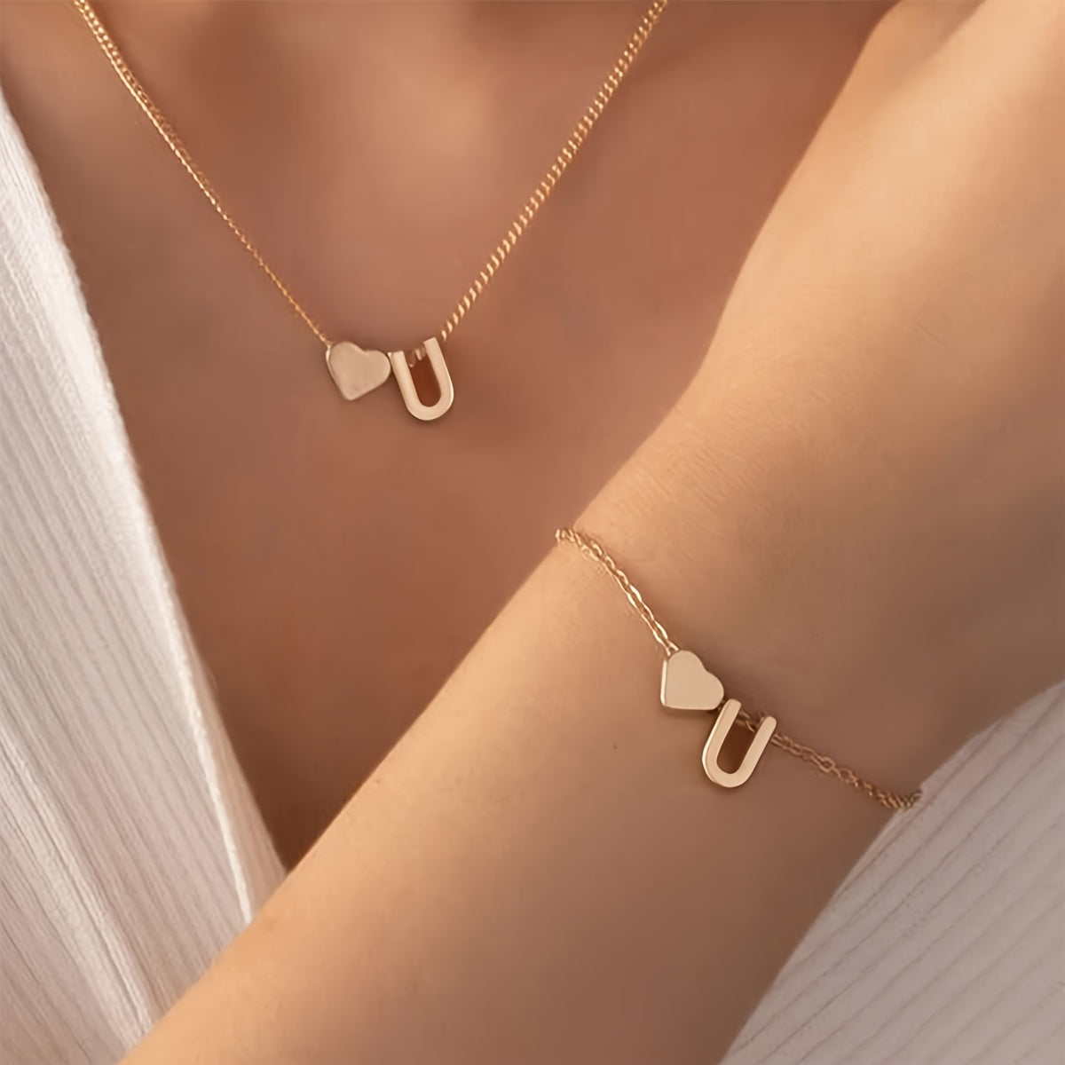 Chic two-piece set with metal heart and letter necklace and bracelet, ideal for daily wear.