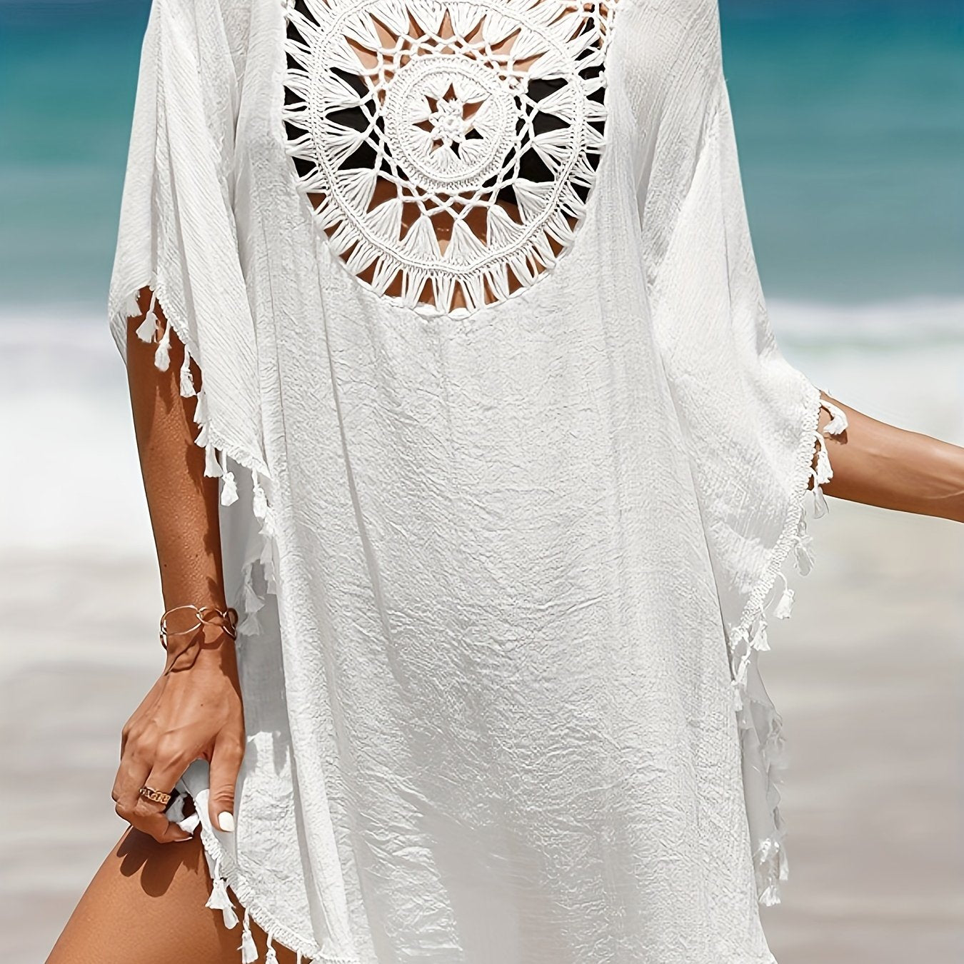 Women's casual beach vacation sunscreen shirt with solid-colored fabric spliced with small tassels for a sexy cover-up style.