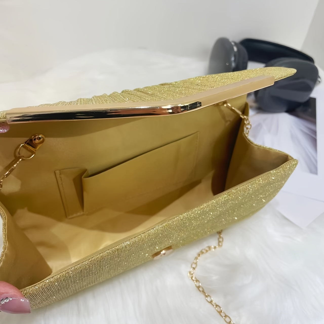 A dazzling envelope clutch adorned with gold accents, ideal for chic women at weddings and parties.