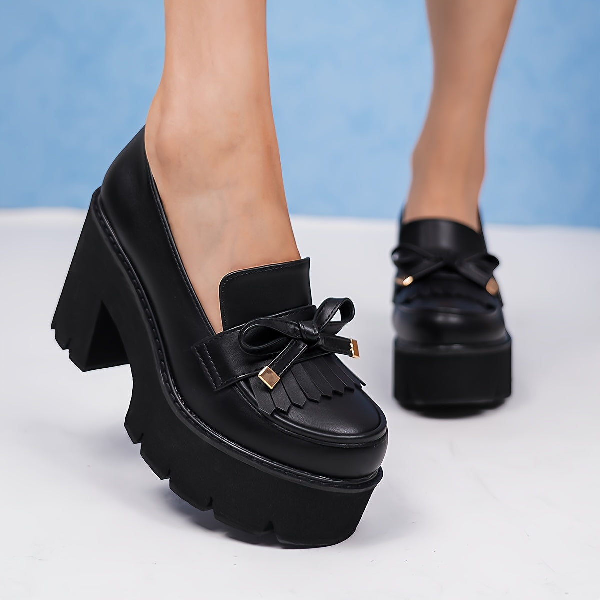 Black platform pumps for women with bow accent. Round toe, high heel shoes with lightweight rubber sole. All-season comfort with man-made materials.