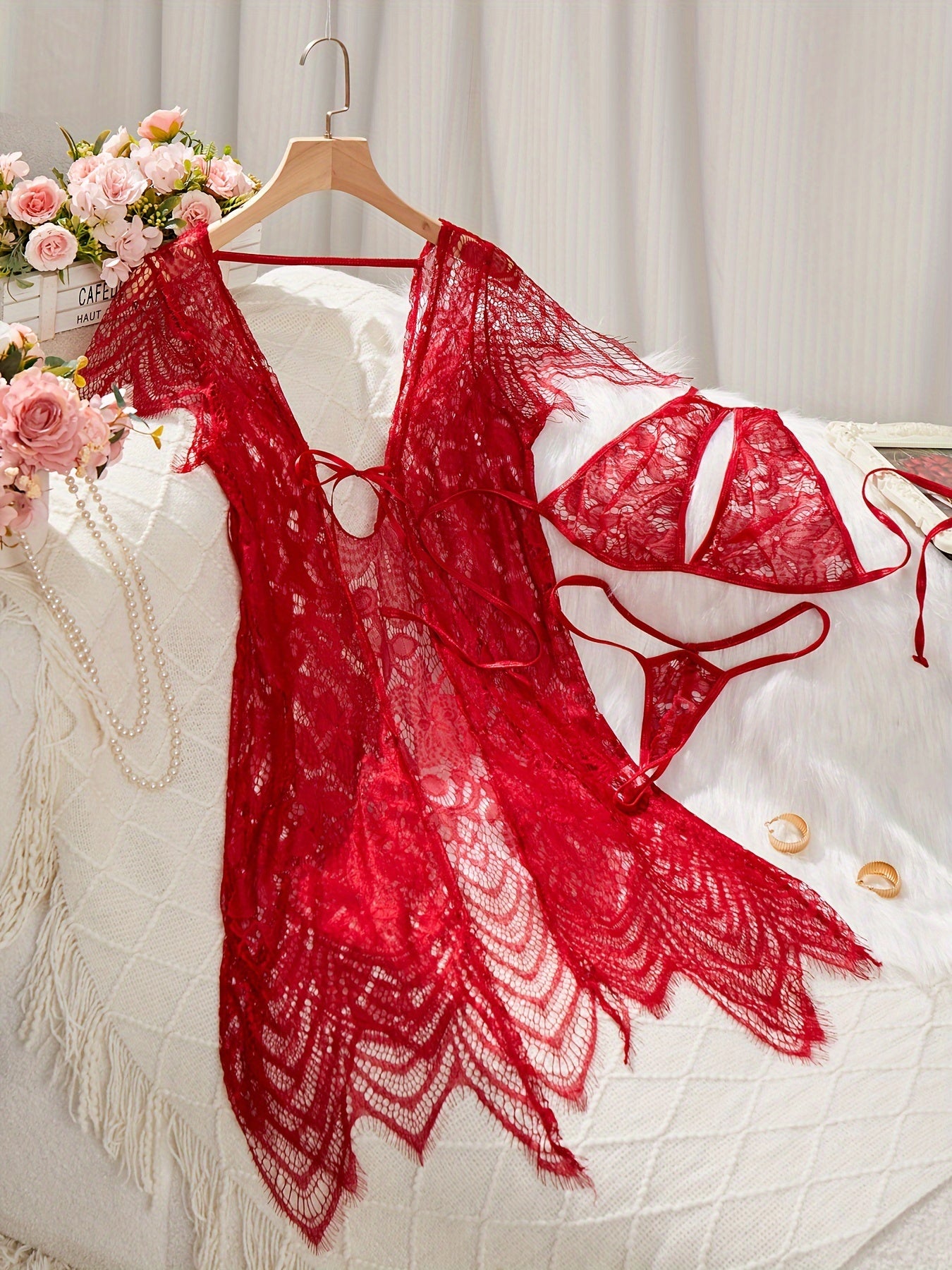 Lace lingerie set with belt and cardigan, bra, and thong for women.