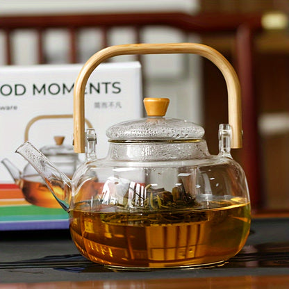 Glass teapot with bamboo handle and removable infuser, 34oz capacity. Made of heat-resistant clear borosilicate glass. Ideal for brewing loose leaf tea.