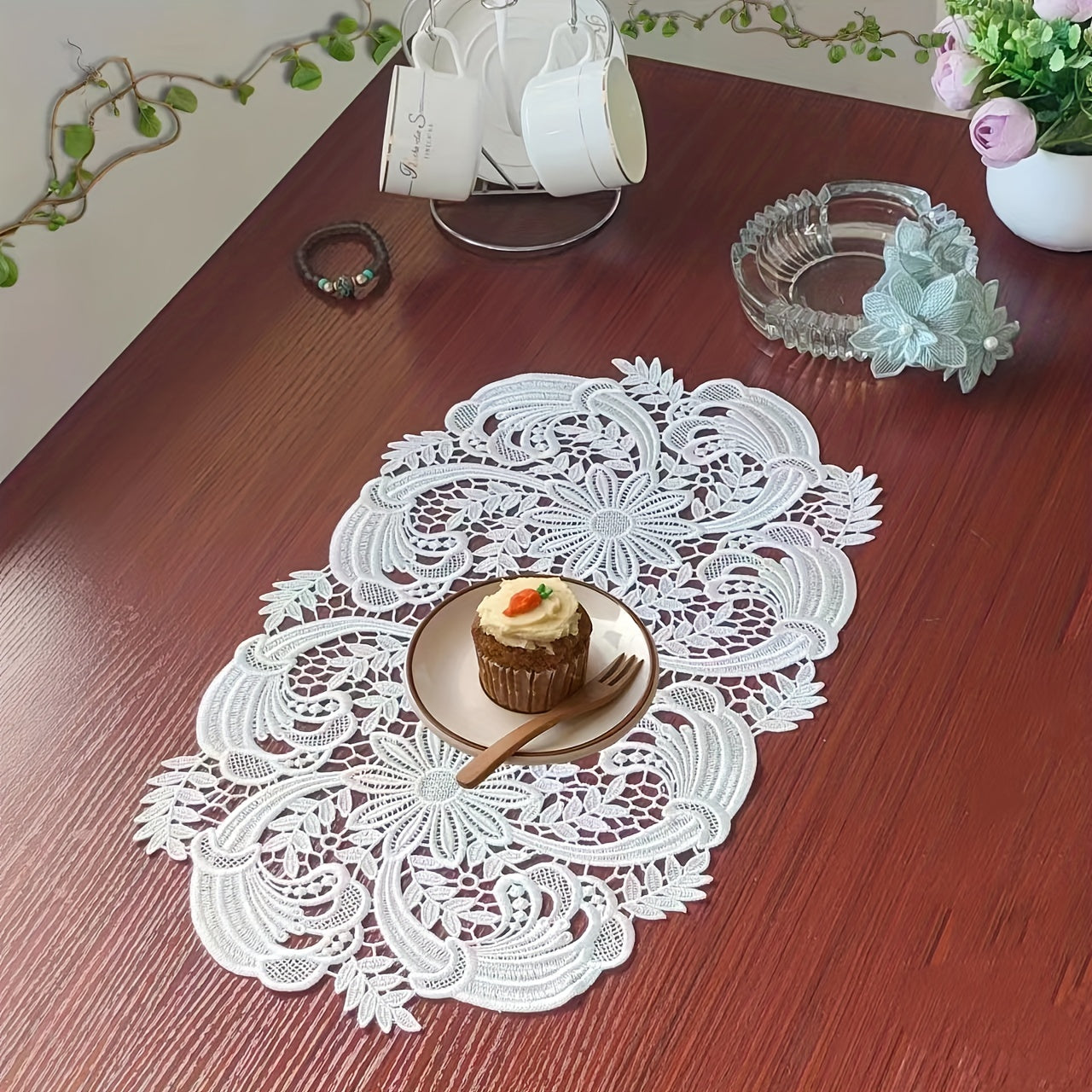 White velvet lace oval table runner with floral pattern, perfect for holiday table setting. Butterfly motif on decorative fabric for dining and home decor.