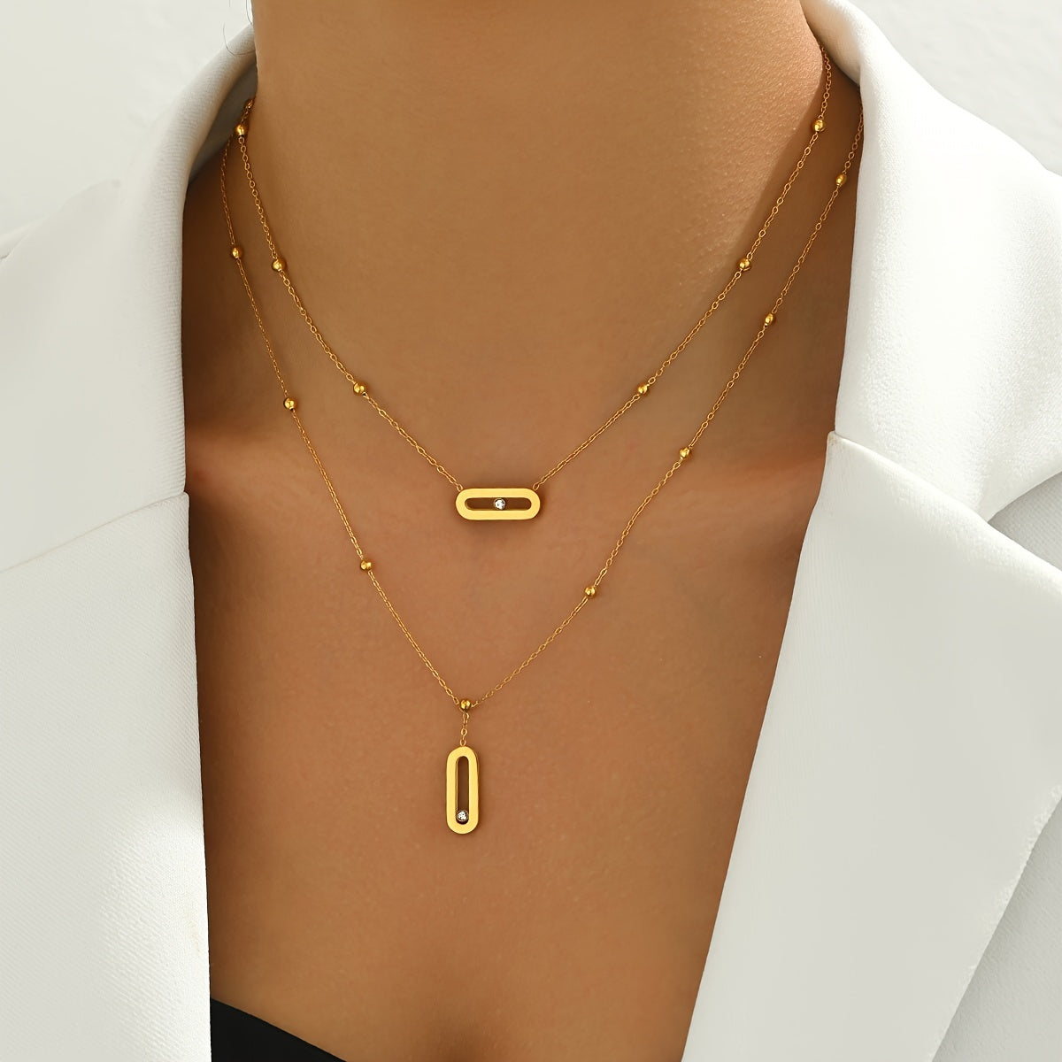 Elevate your look with this sophisticated French-inspired 18K gold plated stainless steel necklace featuring double layers and sparkling rhinestone accents. The versatile geometric pendant is perfect for women, ideal for both everyday wear and as a