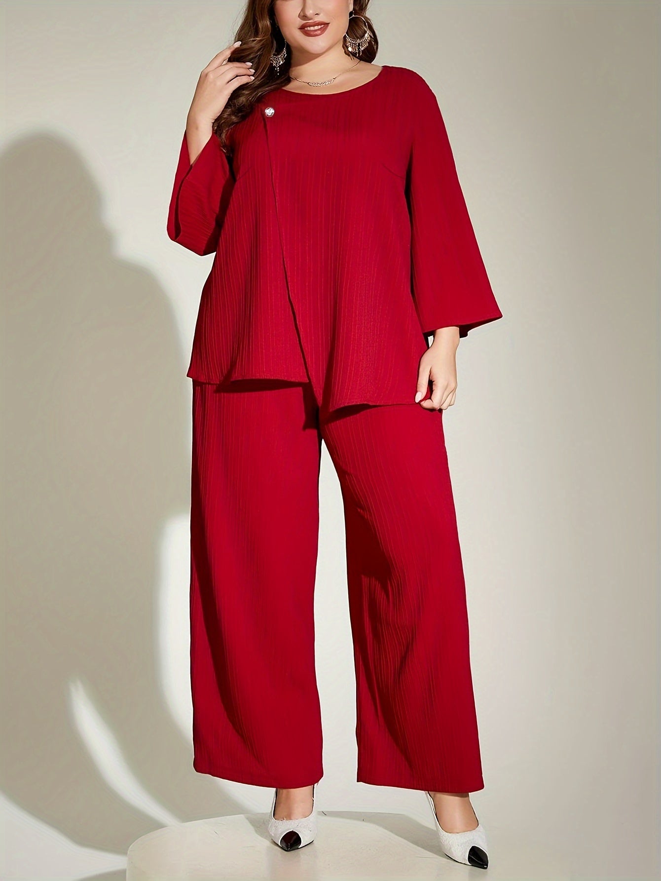 Chic red ribbed suit set for elegant plus size women, includes 3/4 sleeve top and wide-leg pants. Made of polyester, machine washable.