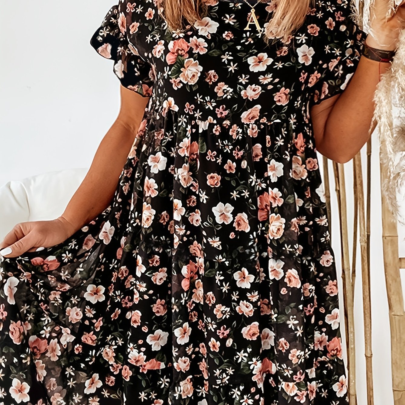 Elegant floral print plus size dress with ruffle detail. Navy blue with pink flowers, perfect for spring and summer. Casual chic style.