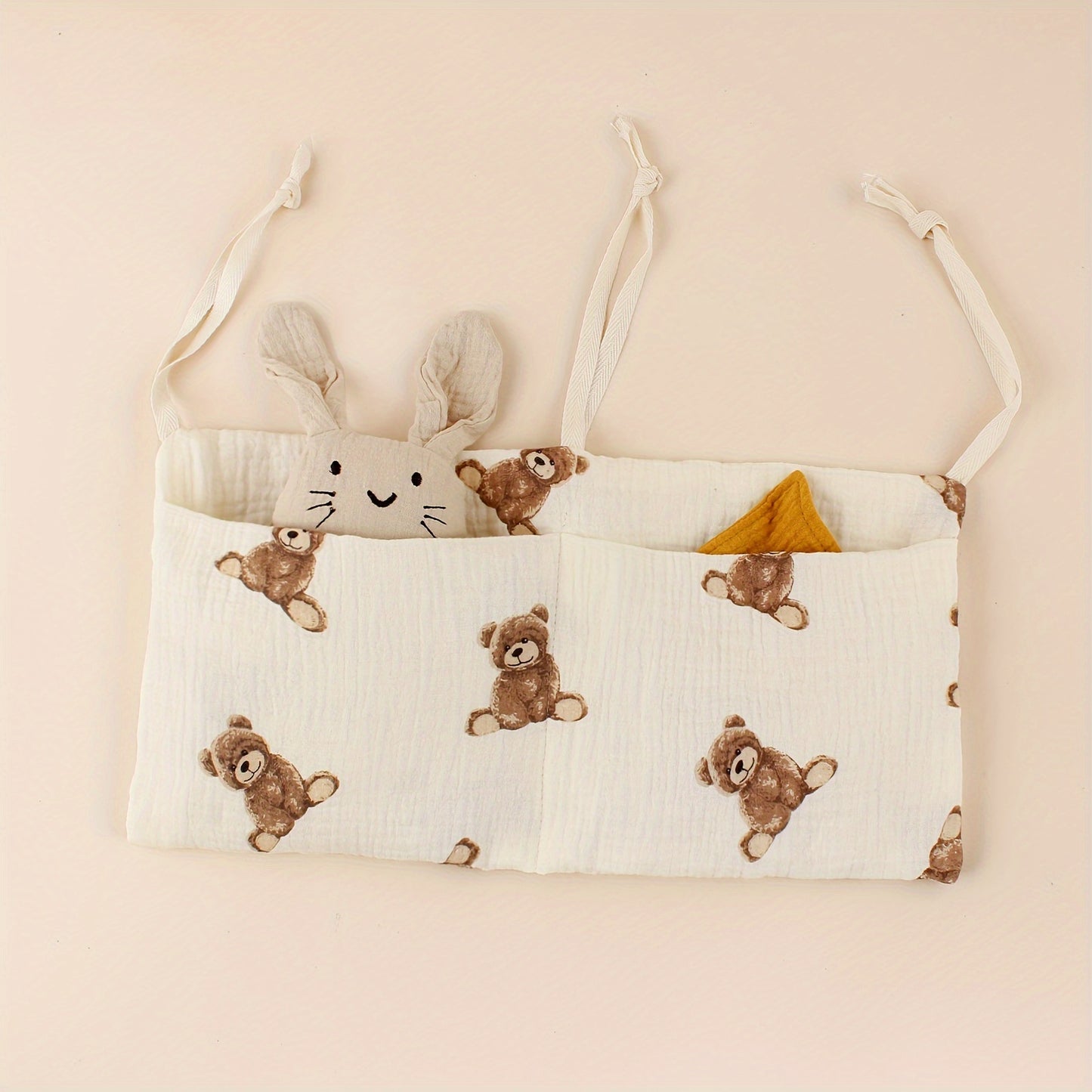 Double-layer fabric hanging storage bag with two stroller pockets, ideal for holding baby bottles with printed patterns.