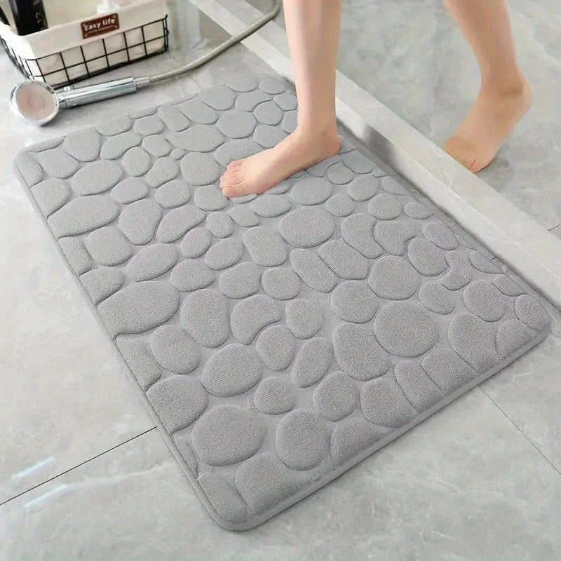 Soft, non-slip coral fleece bathroom mat in a pebble pattern. Quick-dry, machine washable, and low pile for comfort and home decor. Made of plush polyester fiber with knit fabric and 100% polyester material. 570gsm and 1.4cm thick.