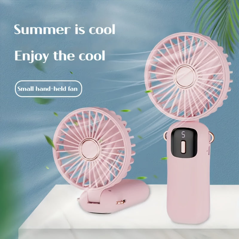 Sleek and stylish white and rose gold Compact & Portable USB Rechargeable Mini Fan with Neck Strap. Perfect for use in the office, classroom, or while traveling. Features a 1200mAh Lithium Battery, desk stand, and includes a power cable for convenient