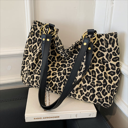 Trendy tote bag with leopard print, black & golden accents, perfect for commuting and shopping.