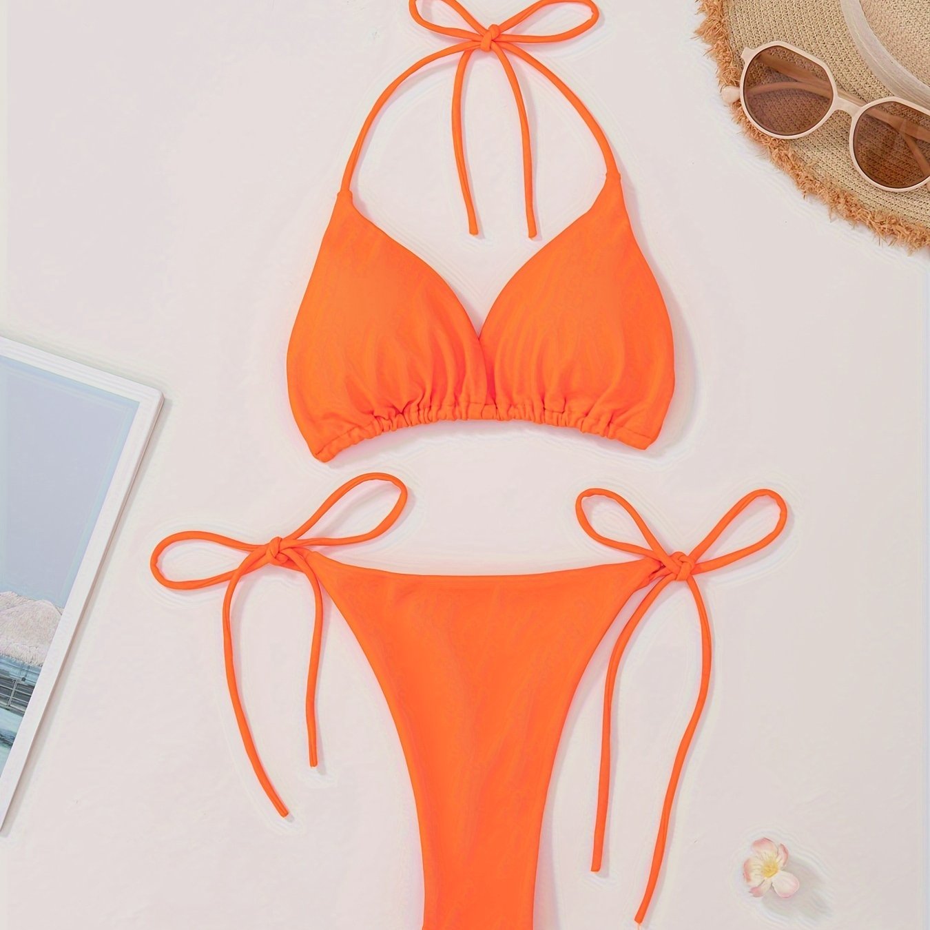 Women's two-piece bikini set with halter bra and V-string bottoms for swimwear.