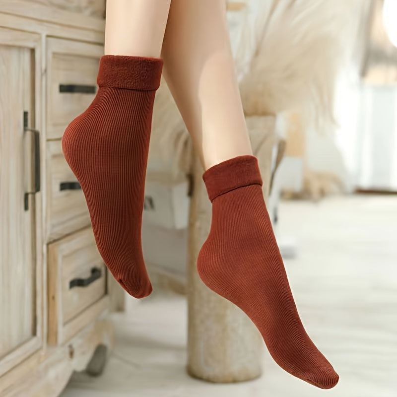 4 pairs of cozy thermal snow socks perfect for winter, lined with fleece for extra warmth, great for casual wear.