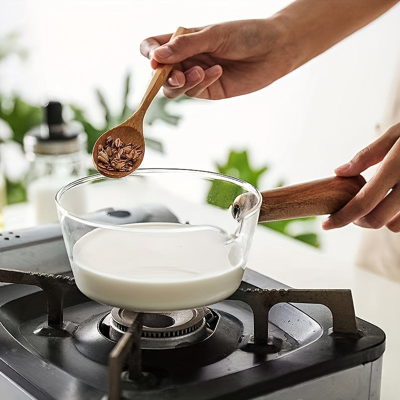 A versatile wooden-handled glass pot set for milk, soup, and noodles including small and large cups. These pots are thickened and heat resistant, perfect for home cooking. Ideal for use in the kitchen as small tools.