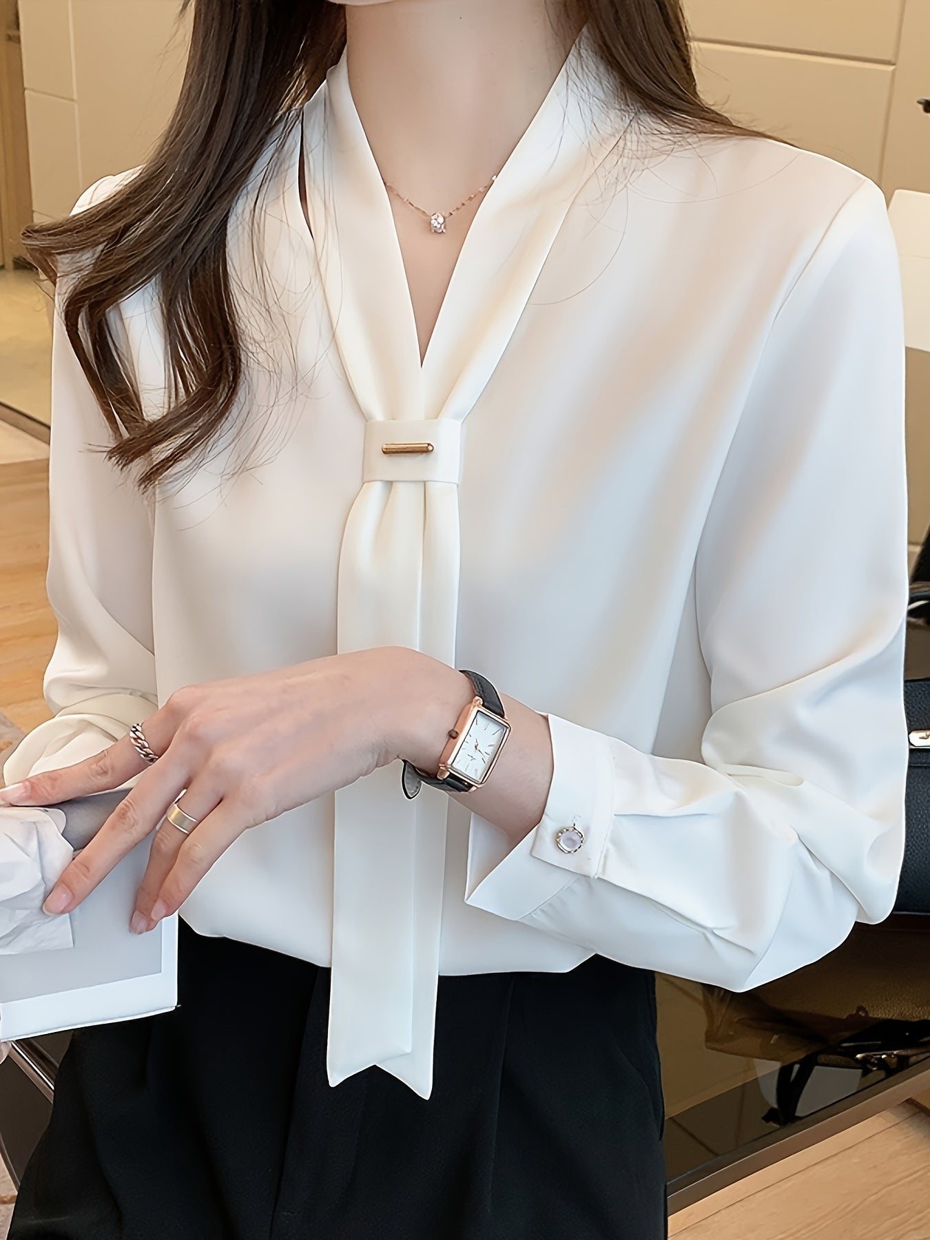 Slimming white chiffon blouse with tie-neck design, perfect for work or casual wear.