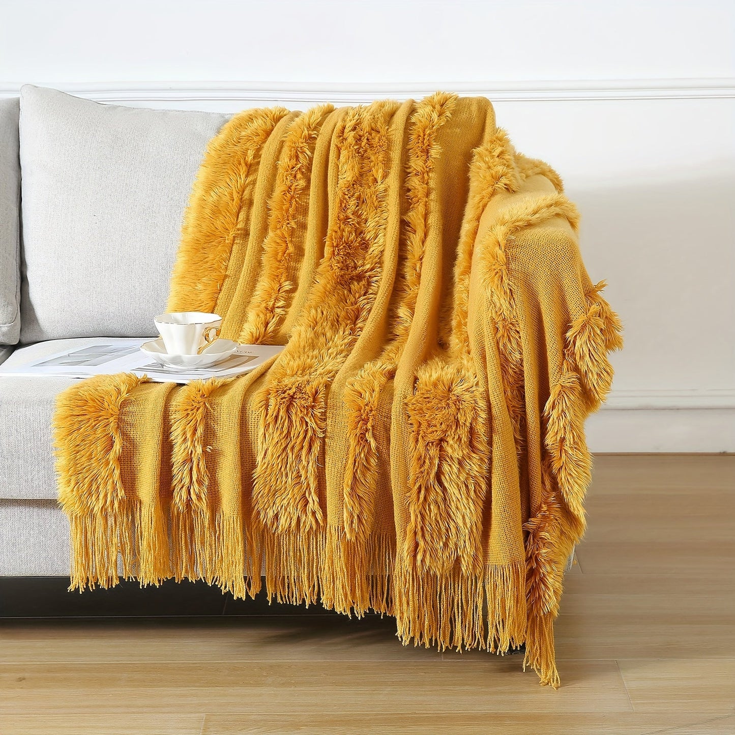 Stay cozy with this contemporary acrylic chunky knit throw blanket featuring tassels. With its solid pattern, lightweight plush texture, and machine washable design, this all-season throw is perfect for adding a touch of style and comfort to your couch