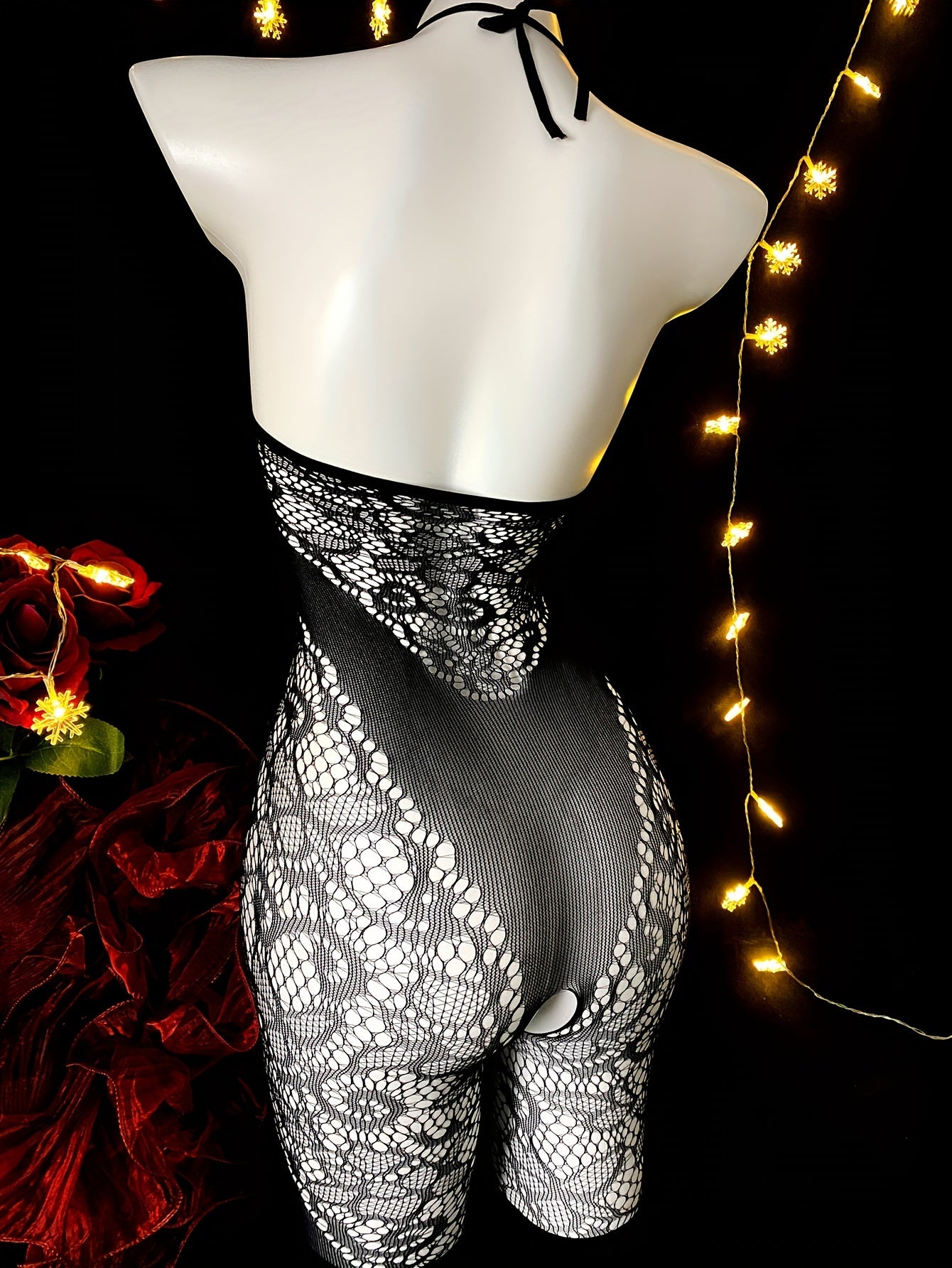 Sleeveless lace bodysuit with fishnet detail made of sheer nylon and elastane. Features high-stretch fabric and chic hollow-out design. Hand washable. For women.