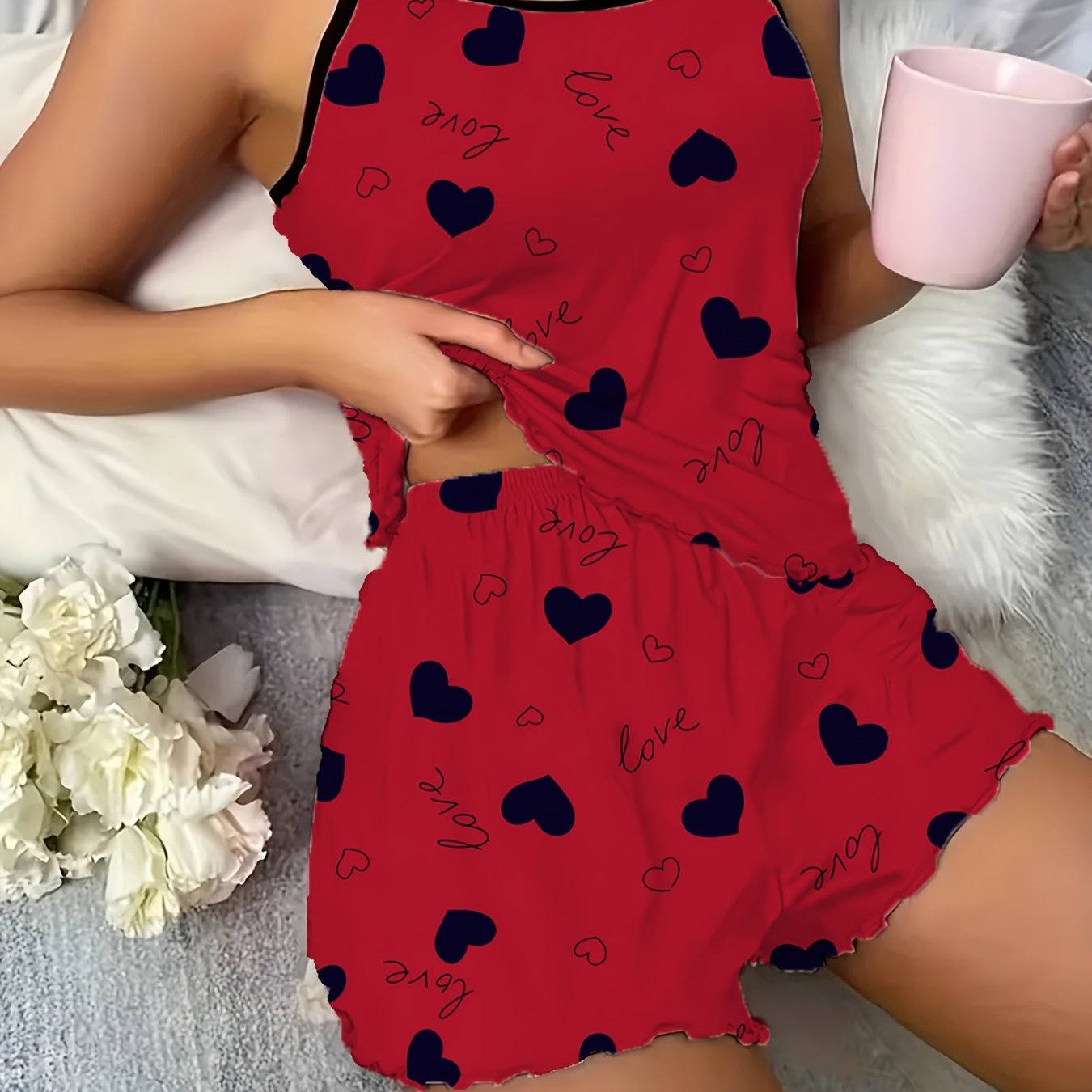 Stylish burgundy heart print pajama set with spaghetti strap top and shorts. Made from soft polyester blend, machine washable.