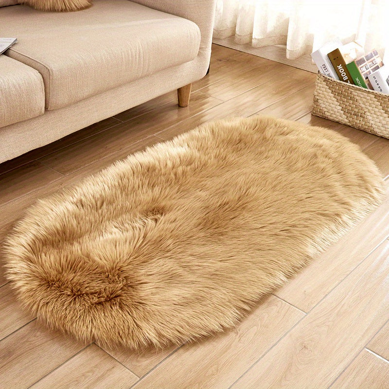 Soft and plush faux sheepskin oval area rug, perfect for adding a cozy touch to any living room or bedroom. Machine washable and designed to be used as a bedside rug. This shaggy plush carpet will enhance your home decor and add a touch of luxury to any