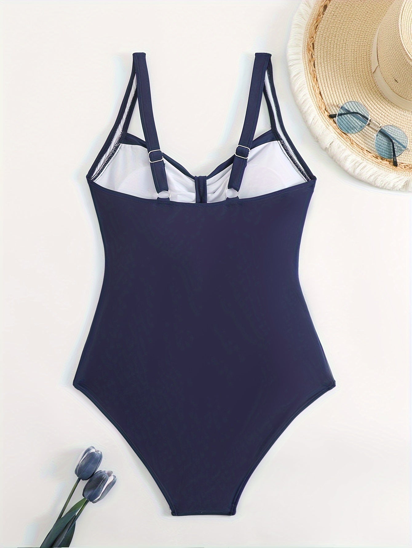 Sexy solid colored one-piece swimsuit with ruched front and high-cut detail for women.